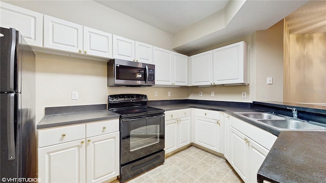 kitchen featuring a sink, dark countertops, white cabinets, and black appliances