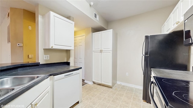 kitchen featuring white cabinets, white dishwasher, dark countertops, a sink, and electric stove