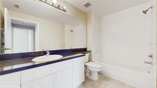 bathroom featuring vanity, shower / bathing tub combination, toilet, and visible vents