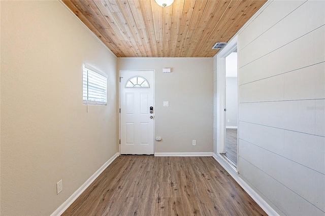 entrance foyer with wooden ceiling, baseboards, wood finished floors, and visible vents