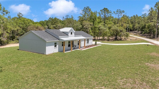 6725 SW 131st Cir, Ocala, FL 34481 - back of property with a lawn, a view of trees, and covered porch