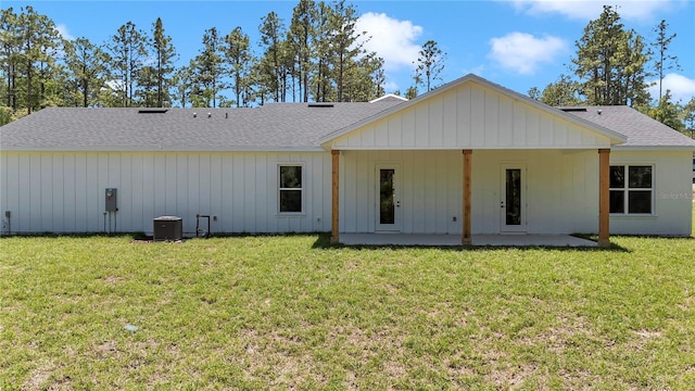 6725 SW 131st Cir, Ocala, FL 34481 - rear view of house with a lawn, a shingled roof, and a patio area