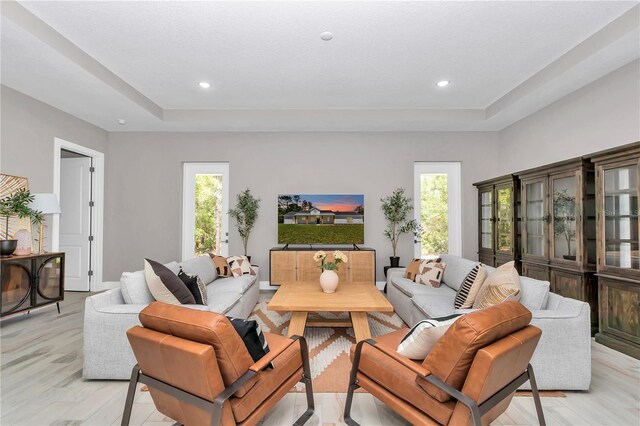 6725 SW 131st Cir, Ocala, FL 34481 - living room featuring recessed lighting, a tray ceiling, and light wood-style floors