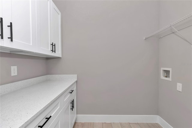 6725 SW 131st Cir, Ocala, FL 34481 - clothes washing area featuring baseboards, hookup for a washing machine, cabinet space, and light wood-style flooring