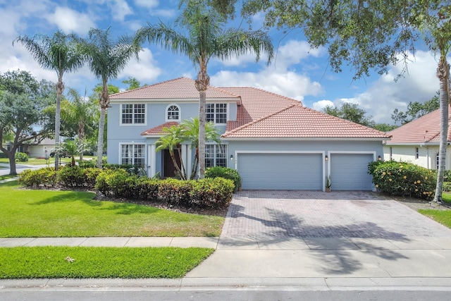1786 Lee Janzen Dr, Kissimmee, FL 34744 - view of front facade featuring a garage, a front lawn, stucco siding, a tiled roof, and driveway