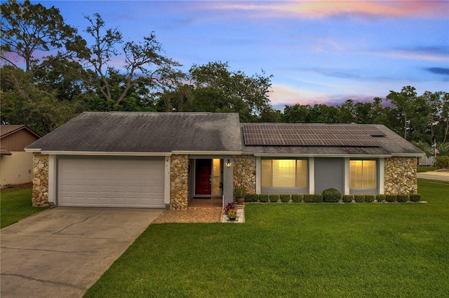 819 Haulover Dr, Altamonte Springs, FL 32714 - view of front of house with stone siding, an attached garage, roof mounted solar panels, and driveway
