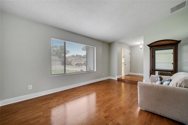 819 Haulover Dr, Altamonte Springs, FL 32714 - living area featuring wood finished floors, a textured ceiling, and baseboards