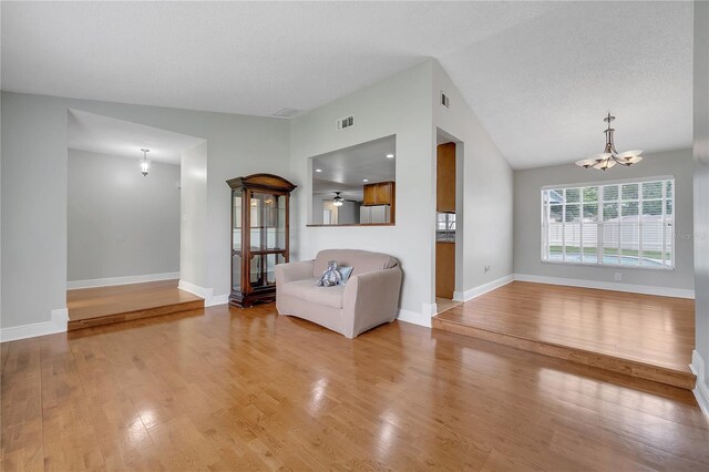 819 Haulover Dr, Altamonte Springs, FL 32714 - sitting room featuring vaulted ceiling, a chandelier, wood finished floors, and baseboards
