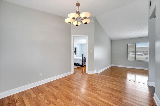 819 Haulover Dr, Altamonte Springs, FL 32714 - empty room with a chandelier, light wood finished floors, vaulted ceiling, and baseboards