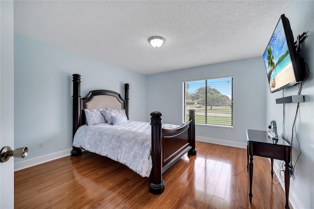 819 Haulover Dr, Altamonte Springs, FL 32714 - bedroom featuring a textured ceiling, wood finished floors, and baseboards