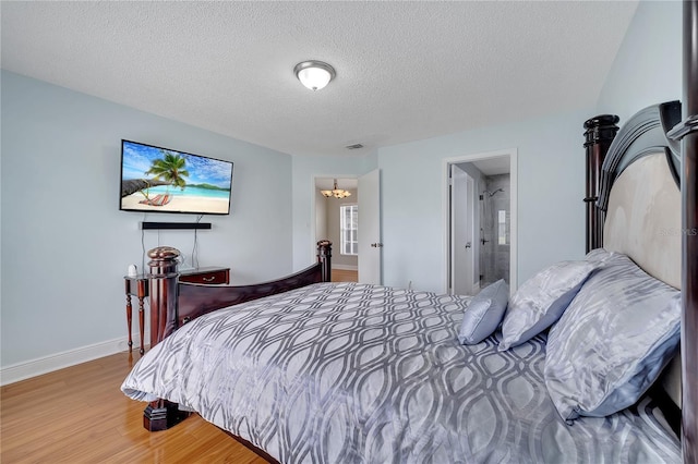 819 Haulover Dr, Altamonte Springs, FL 32714 - bedroom featuring wood finished floors, a textured ceiling, a chandelier, and baseboards