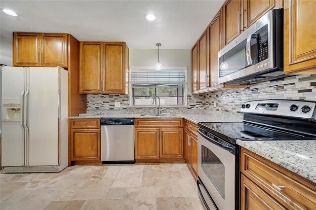 819 Haulover Dr, Altamonte Springs, FL 32714 - kitchen featuring stainless steel appliances, a sink, brown cabinetry, backsplash, and recessed lighting