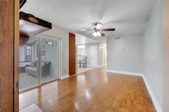 819 Haulover Dr, Altamonte Springs, FL 32714 - empty room with a ceiling fan, light wood finished floors, baseboards, and a textured ceiling