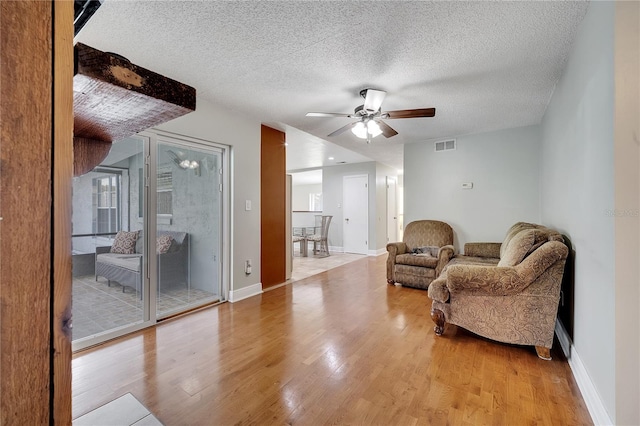 819 Haulover Dr, Altamonte Springs, FL 32714 - sitting room featuring ceiling fan, wood finished floors, baseboards, and a textured ceiling
