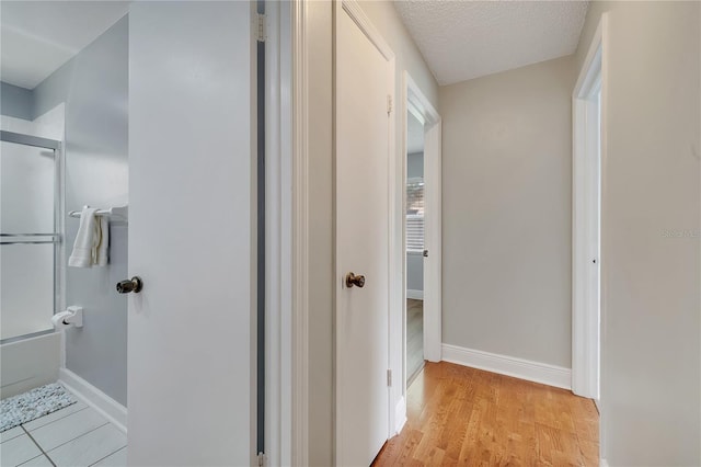 819 Haulover Dr, Altamonte Springs, FL 32714 - hallway with baseboards, a textured ceiling, and light wood-style floors