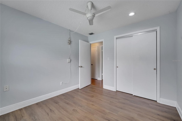 819 Haulover Dr, Altamonte Springs, FL 32714 - unfurnished bedroom featuring a textured ceiling, baseboards, wood finished floors, a closet, and ceiling fan