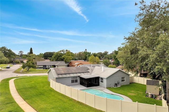 819 Haulover Dr, Altamonte Springs, FL 32714 - back of property featuring a sunroom, roof mounted solar panels, a shingled roof, stucco siding, and a residential view
