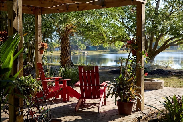 view of patio featuring an outdoor fire pit and a water view