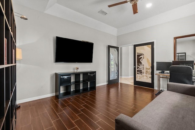 office featuring a ceiling fan, visible vents, wood finished floors, and baseboards