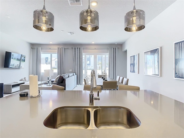 7770 Sandy Ridge Dr Unit 139, Reunion, FL 34747 - interior space with light countertops, visible vents, a sink, and hanging light fixtures