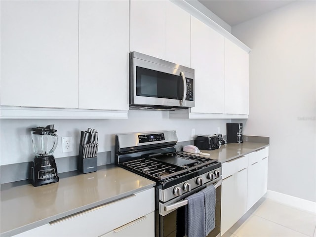 7770 Sandy Ridge Dr Unit 139, Reunion, FL 34747 - kitchen featuring modern cabinets, white cabinets, and appliances with stainless steel finishes