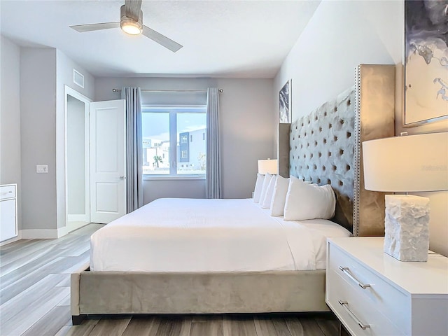 7770 Sandy Ridge Dr Unit 139, Reunion, FL 34747 - bedroom with wood finished floors, visible vents, baseboards, and ceiling fan