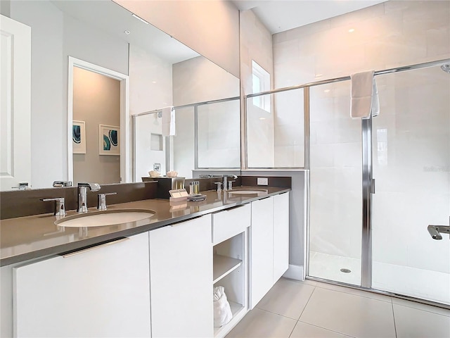 7770 Sandy Ridge Dr Unit 139, Reunion, FL 34747 - bathroom featuring double vanity, a shower stall, tile patterned flooring, and a sink