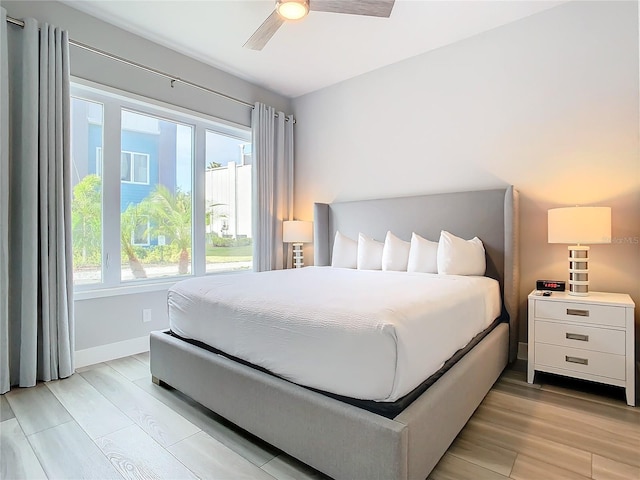 7770 Sandy Ridge Dr Unit 139, Reunion, FL 34747 - bedroom with baseboards, multiple windows, and light wood-type flooring