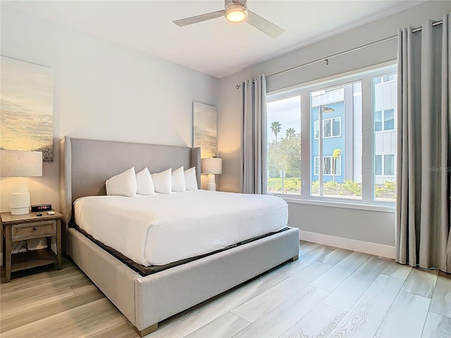7770 Sandy Ridge Dr Unit 139, Reunion, FL 34747 - bedroom with light wood finished floors, baseboards, and ceiling fan