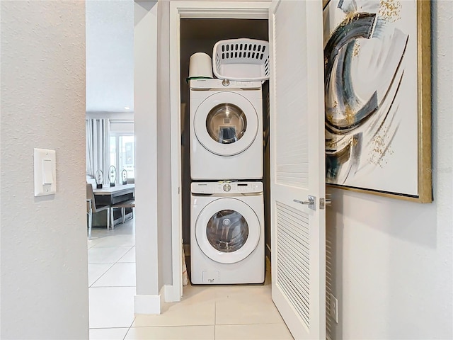 7770 Sandy Ridge Dr Unit 139, Reunion, FL 34747 - washroom with light tile patterned flooring and stacked washing maching and dryer