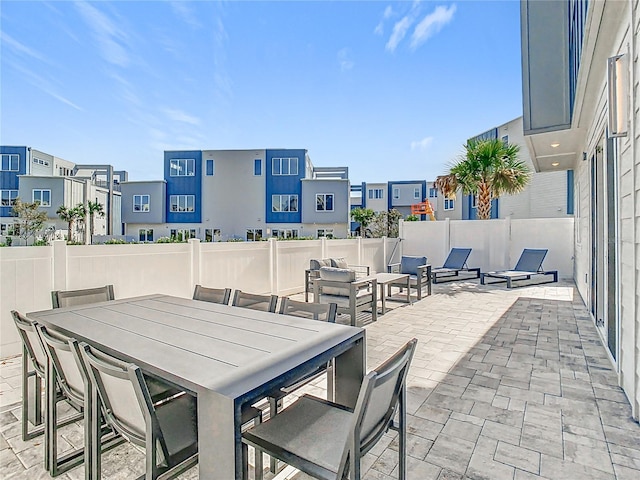 7770 Sandy Ridge Dr Unit 139, Reunion, FL 34747 - view of patio featuring fence, outdoor dining area, and a residential view