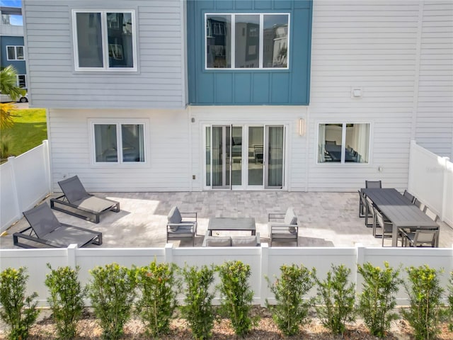7770 Sandy Ridge Dr Unit 139, Reunion, FL 34747 - rear view of house with a fenced backyard, a patio, and board and batten siding