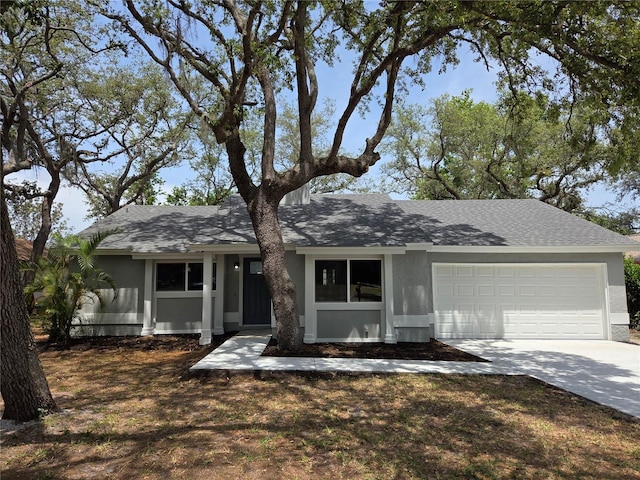 single story home with stucco siding, driveway, roof with shingles, and a garage