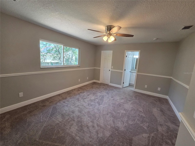 interior space with ceiling fan, a textured ceiling, visible vents, and carpet