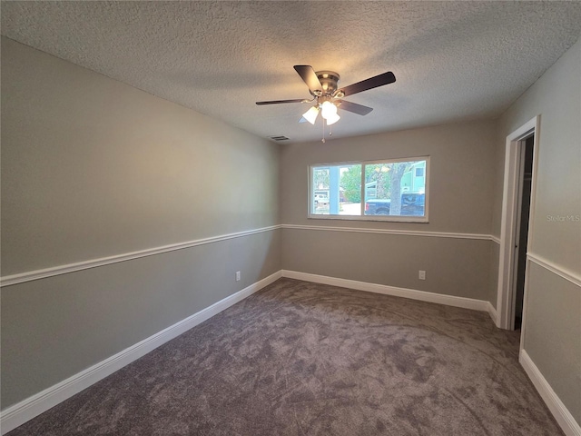 spare room featuring a textured ceiling, carpet flooring, a ceiling fan, and baseboards