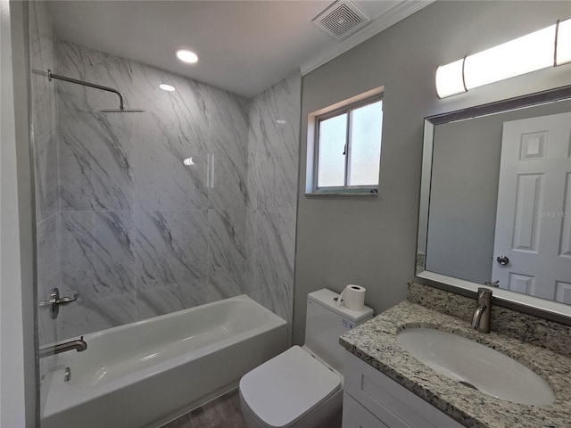 bathroom with visible vents, toilet, vanity, and  shower combination