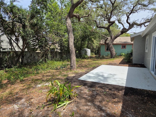 view of yard with fence and a patio