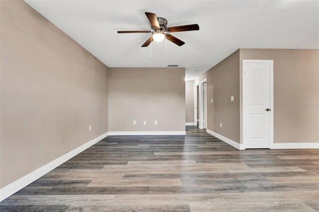516 Polaris Loop Unit 110, Casselberry, FL 32707 - empty room with visible vents, a ceiling fan, baseboards, and wood finished floors