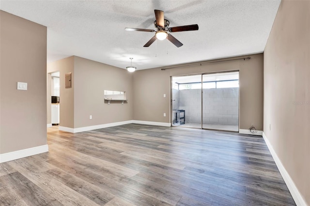 516 Polaris Loop Unit 110, Casselberry, FL 32707 - empty room with baseboards, a ceiling fan, a textured ceiling, and wood finished floors