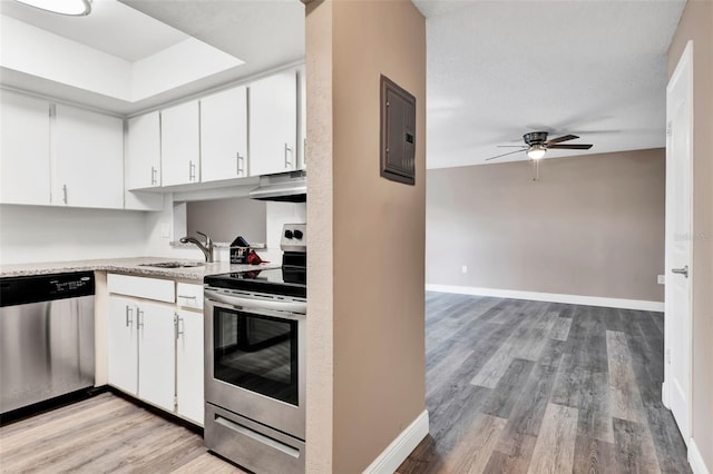 516 Polaris Loop Unit 110, Casselberry, FL 32707 - kitchen featuring ceiling fan, stainless steel appliances, light wood-type flooring, under cabinet range hood, and electric panel