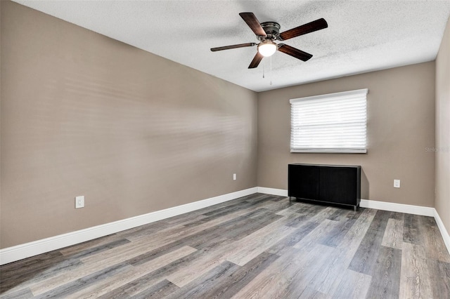 516 Polaris Loop Unit 110, Casselberry, FL 32707 - spare room featuring baseboards, a ceiling fan, a textured ceiling, and wood finished floors