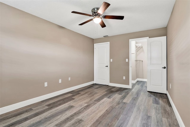 516 Polaris Loop Unit 110, Casselberry, FL 32707 - unfurnished bedroom featuring visible vents, wood finished floors, baseboards, a closet, and a spacious closet