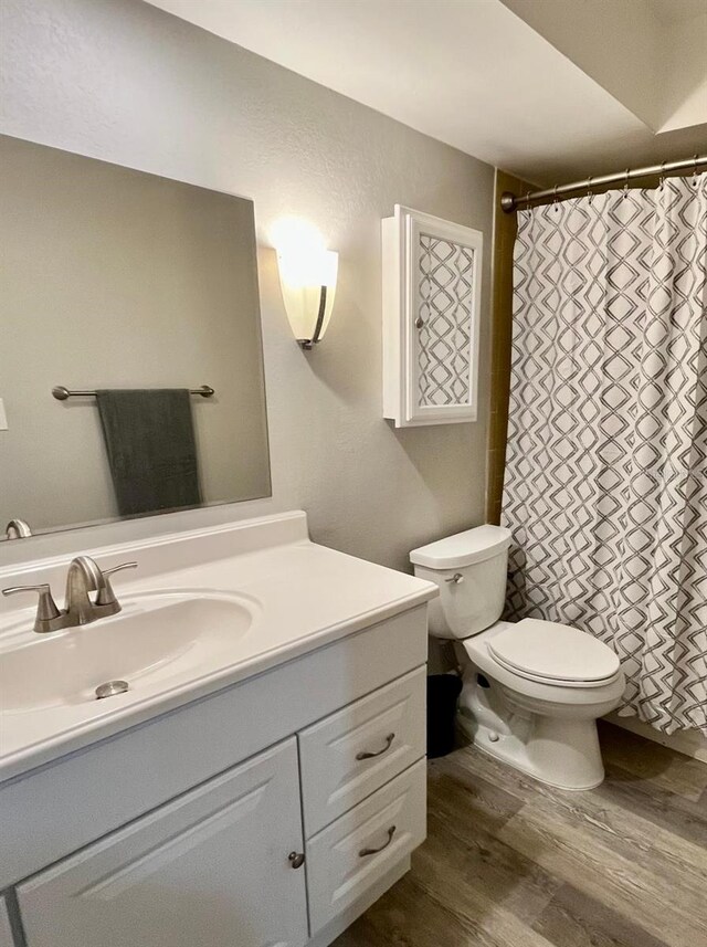 516 Polaris Loop Unit 110, Casselberry, FL 32707 - full bathroom with toilet, a shower with curtain, wood finished floors, and vanity