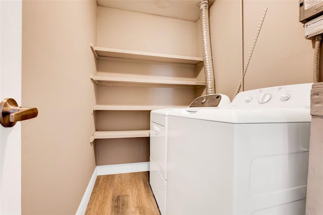 516 Polaris Loop Unit 110, Casselberry, FL 32707 - laundry room featuring laundry area, baseboards, independent washer and dryer, and wood finished floors
