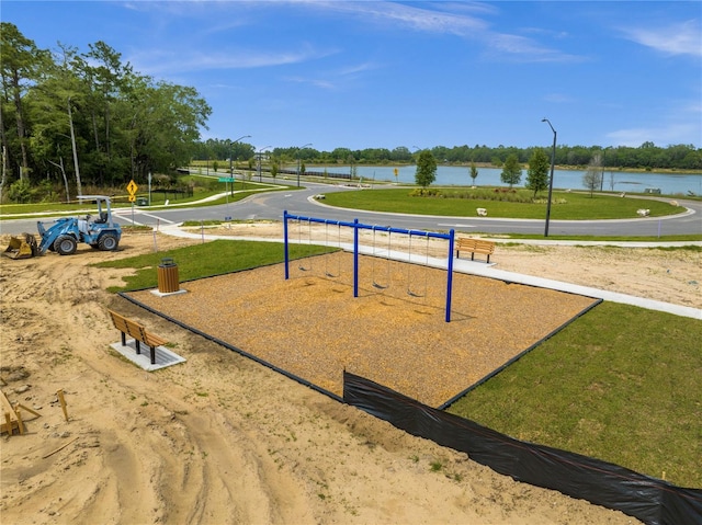 view of community with a lawn, a water view, and volleyball court