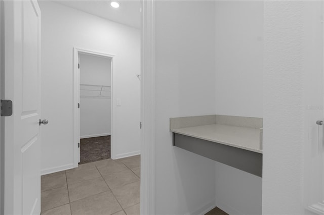bathroom with baseboards, tile patterned floors, and recessed lighting