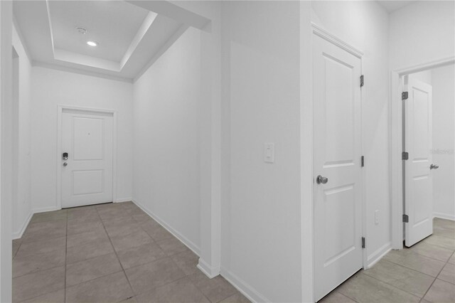 corridor with light tile patterned flooring, baseboards, and recessed lighting