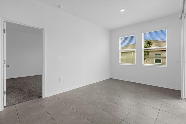 unfurnished room featuring recessed lighting, tile patterned floors, and baseboards