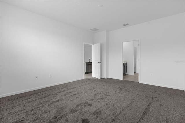 unfurnished bedroom with visible vents, carpet flooring, and baseboards