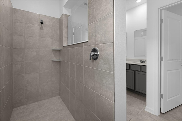 full bathroom with tile patterned floors, vanity, and a walk in shower